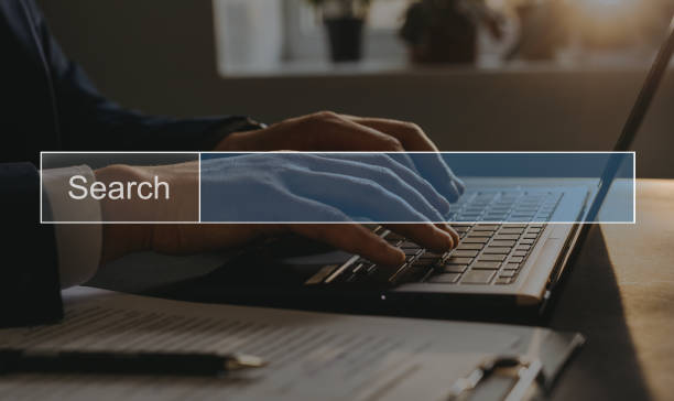 istock BusinessMan tapping laptop keyboard and search page on computer touch screen.SEO Concept Searching. Copy space. 1225376067
