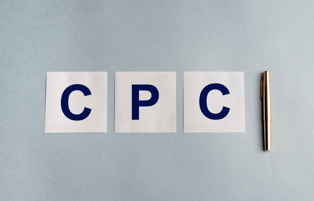 istock CPC (Cost Per Click) acronym word text on white stickers paper notes and golden pen on a grey blue background. Business SMM and digital marketing concept 1225379051