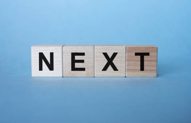 istock Next Word Written In Wooden Cubes on light blue background 1225379278
