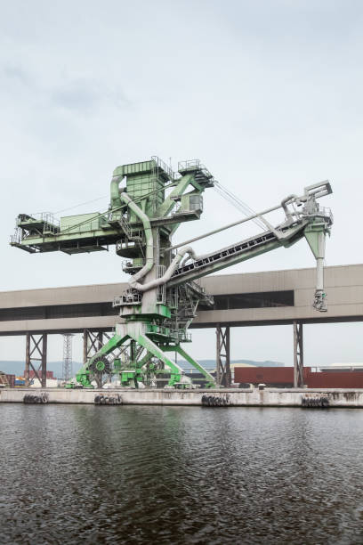 istock Green port crane for bulk products loading, close-up 1225379411