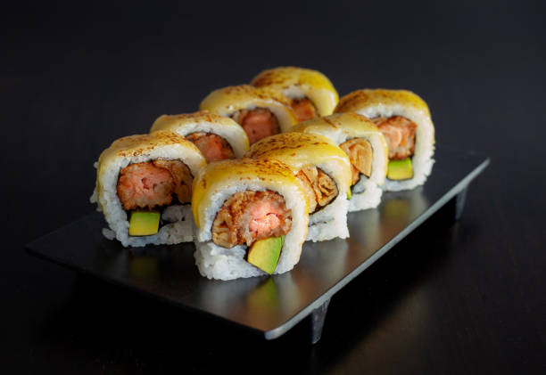 istock Sushi roll with fried salmon, avocado and melted cheese 1225379505