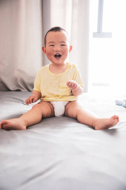 istock Asian baby looking at camera laughing 1225380132