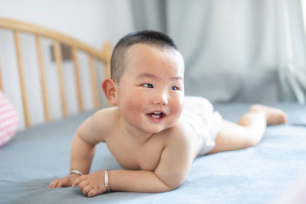 istock Asian baby lying in bed 1225380147