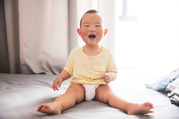 istock Asian baby looking at camera laughing 1225380219