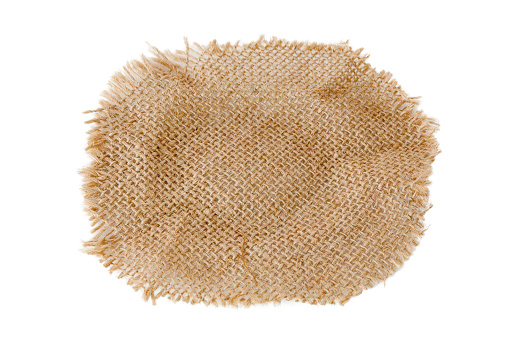 Brown burlap cloth isolated on white background with clipping paths for graphic design. Aged fabric that is woven from natural fibers in a vintage style. Abstract texture for wallpaper
