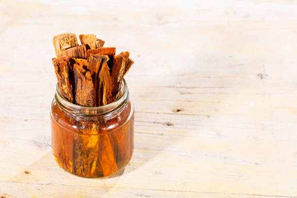 Various kinds of double salted licorice, salmiak, salmiakki on display in clear glass jar and on table with white background and copy space