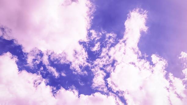 istock Sky background. Beautiful pink purple sky with white clouds. 16:9. 1225383628