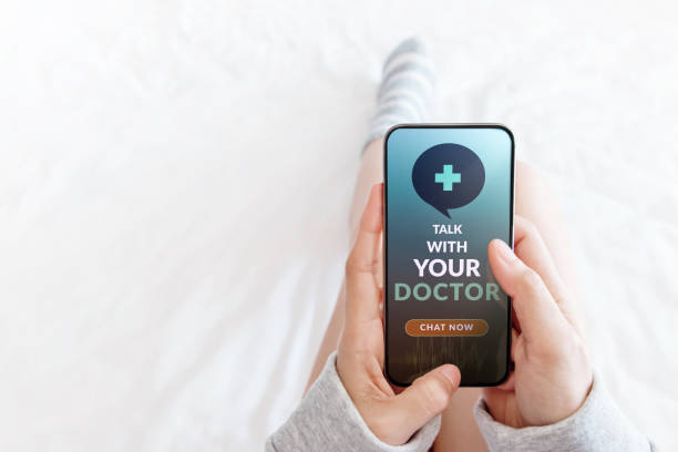 istock Helathy Lifestyle and Technology Concept. Modern Person Using Online Medicine Application via Mobile Phone to Request a Consultation from the Doctor. Lying in Bed using Smartphone in Top View 1225384656