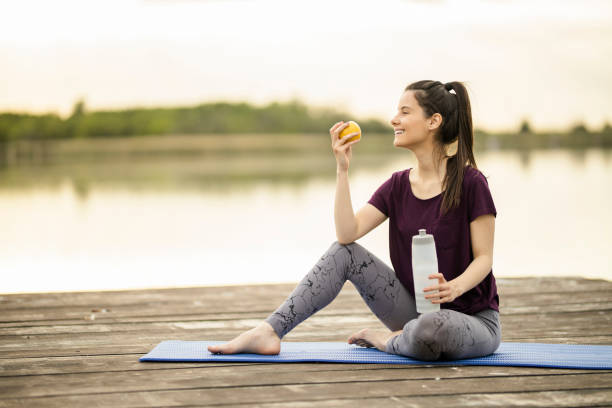 istock Woman eating apple and drinking water 1225384658