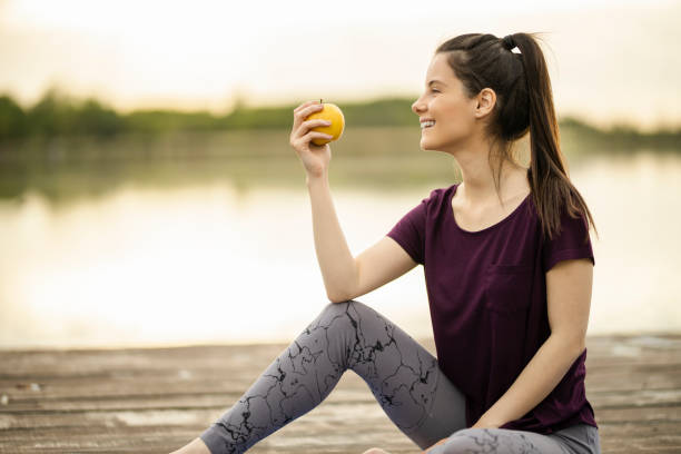 Sporty woman eating apple