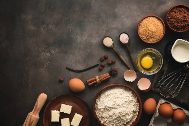 istock Baking background. Ingredients variety for cooking dough on a dark rustic table. The recipe for making chocolate cake and cookies. Top view, flat lay, copy space. 1225385120