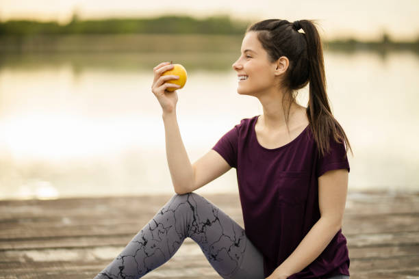 istock Woman eating apple and drinking water 1225385235