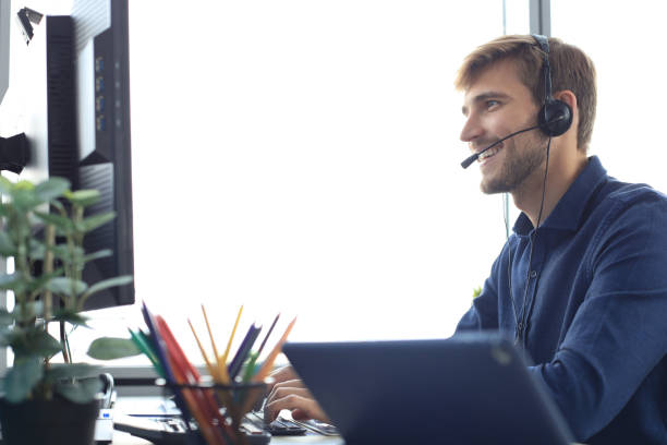 istock Happy young male customer support executive working in office. 1225386799