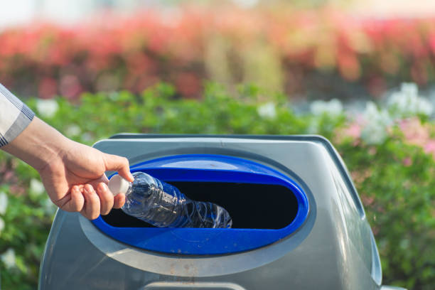 istock Hand throwing plastic bag into recycling bin, concept of environmental protection 1225387969