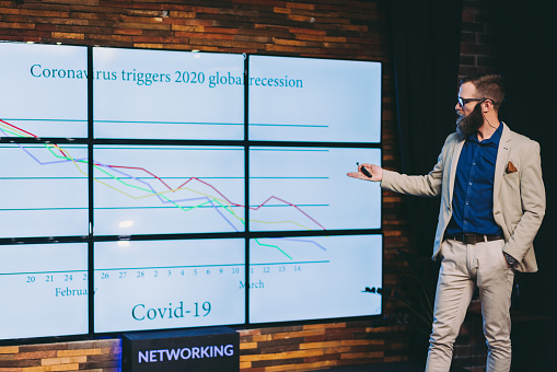 Financial analyst giving presentation about COVID-19 pandemic and it’s influence on economic slowdown