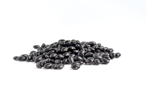 Black gram (Vigna mungo) or A Pile of Dry black beans isolated on white background.
