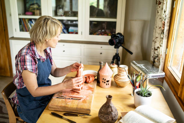 istock Mid age sculptor working at home 1225389872