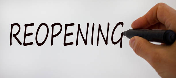 istock Hand writing 'reopening', isolated on beautiful white background. Concept. 1225389922