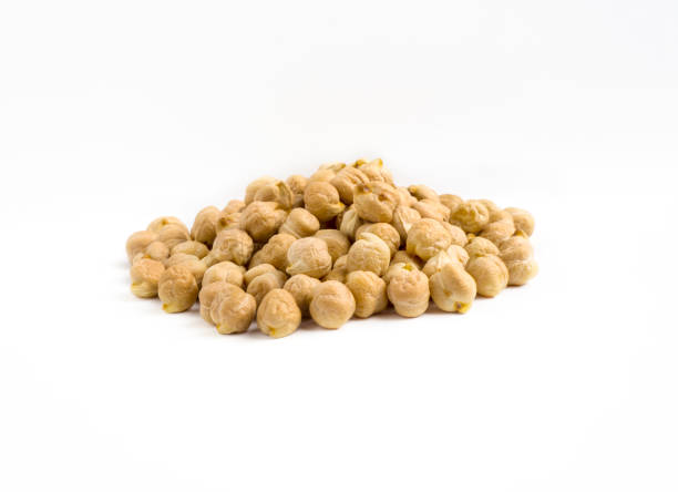 istock Dry raw organic chickpeas isolated on white background. Chickpeas in a pile 1225389983