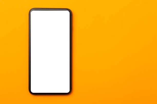 istock Flat lay, top view of orange office table desk with smartphone blank screen mockup with clipping path. Modern working space 1225390578
