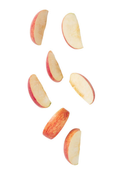 istock Falling red apple slice isolated on white background with clipping path 1225390591