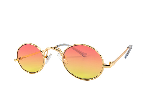 Vintage sunglasses with oval shaped gold wrap around frames and orange gradient lenses, isolated on white background, side view.
