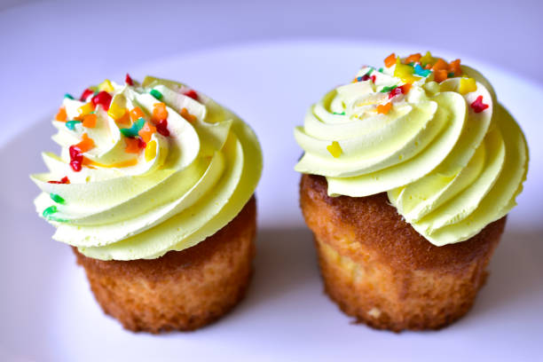 istock Yellow cake with multicolored fruit sprinkles on a white background 1225391104