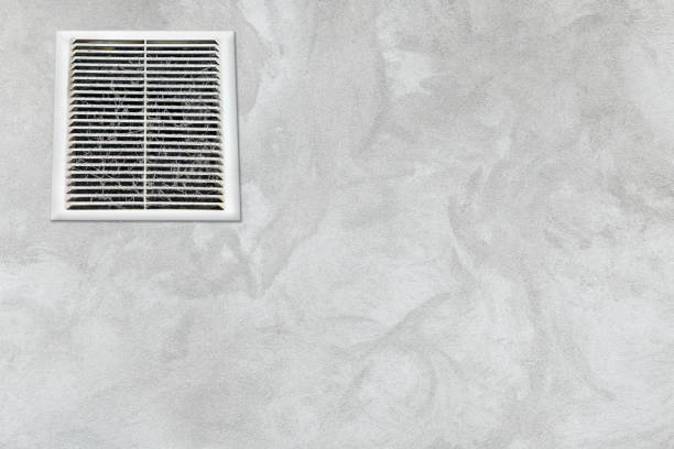 Dirty, dusty ventilation grill in a concrete gray wall. Background for inscriptions.