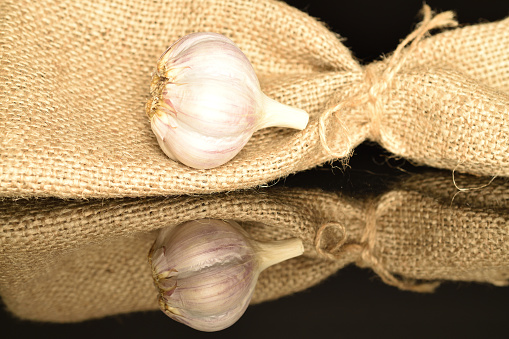 Fresh fragrant garlic, close-up on a black background.