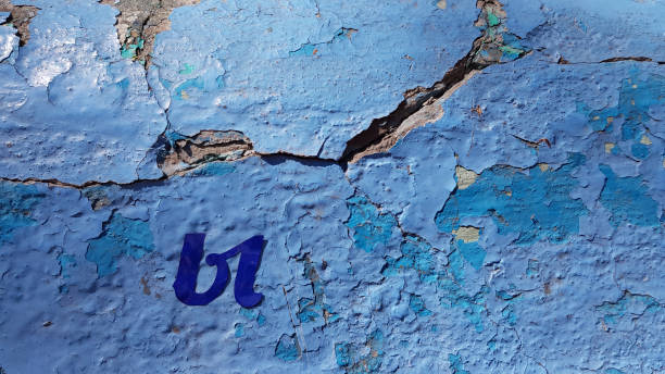 istock Deep cracks of grunge blue wall texture with peeling paint 1225394688