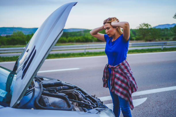 istock Woman with broken car 1225398896