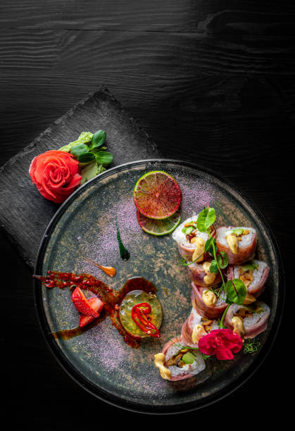 istock sushi roll in plate on black wooden table background 1225400164