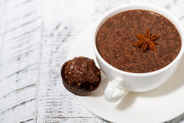 istock cup of hot chocolate and chocolate candy, top view 1225401171