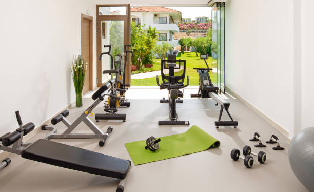 Modern concept of green nature eco style gym. Front view of stylish training room interior in hotel, apartment, house with open air garden window Modern concept of green nature eco style gym. Front view of stylish training room interior in hotel, apartment, house with open air garden window health club stock pictures, royalty-free photos & images