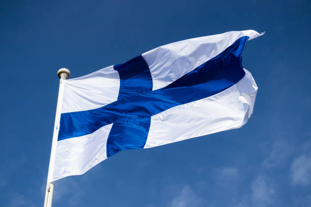 istock Finnish national flag on the wind against the blue sky 1225403700