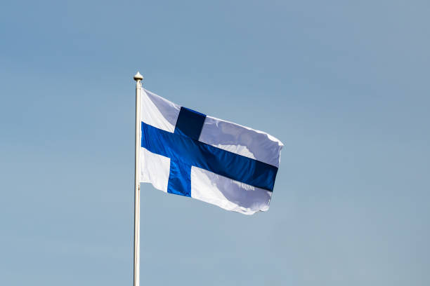 istock Finnish national flag on the wind against the blue sky 1225403713