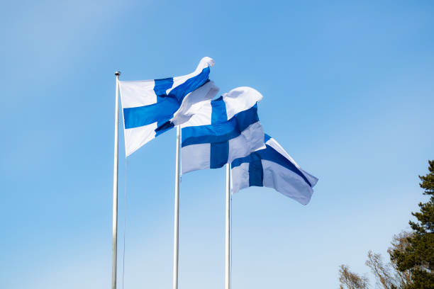 istock Finnish national flag on the wind against the blue sky 1225404382
