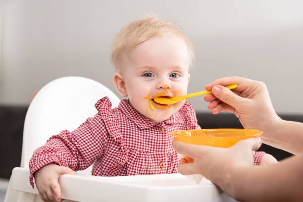 istock Baby Child Eating In Chair 1225404865
