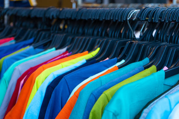 istock Multi-colored t-shirts on a hanger. Clothing store 1225406348