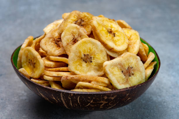 istock Healthy snack, crispy dehydrated unsugared banana chips in bowl 1225407165