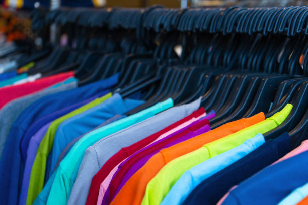 istock Multi-colored t-shirts on a hanger. Clothing store 1225407540