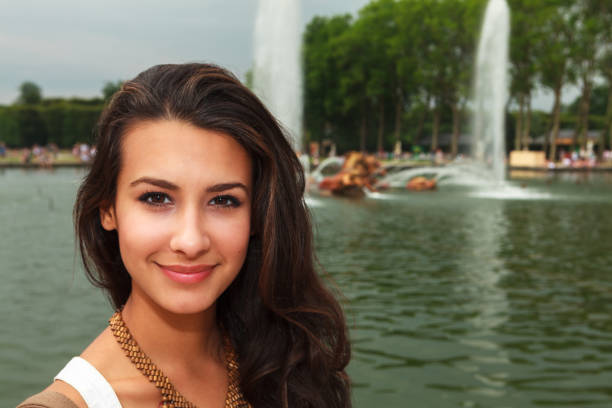 Beautiful young woman enjoying the fountains in Paris.