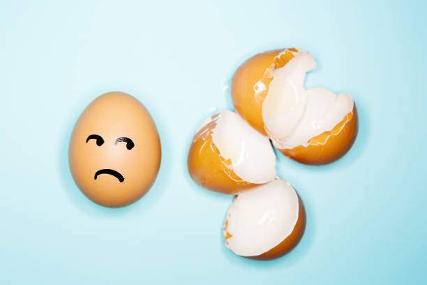 istock Surviving egg looks at broken eggshells in fear 1225409728