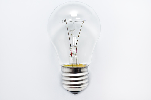 one incandescent bulb lying on white