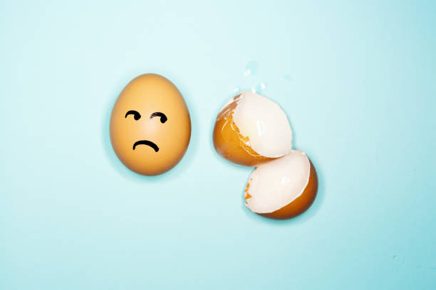 istock Surviving egg looks at broken eggshells in fear 1225410255