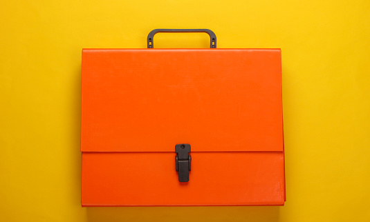 Orange paper case on a yellow background. Top view