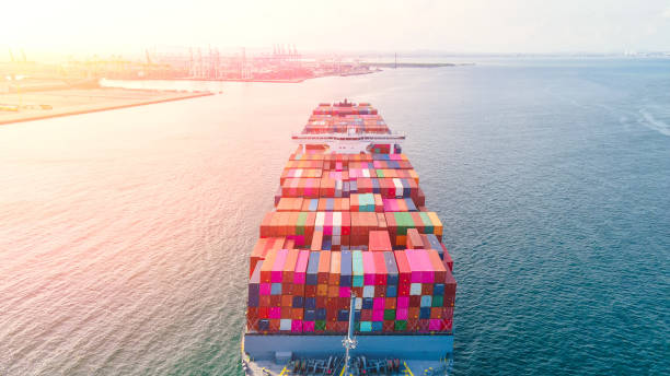 istock Container , container ship in export and import business and logistics. Shipping cargo to harbor by crane. Water transport International. Aerial view and top view. 1225410347