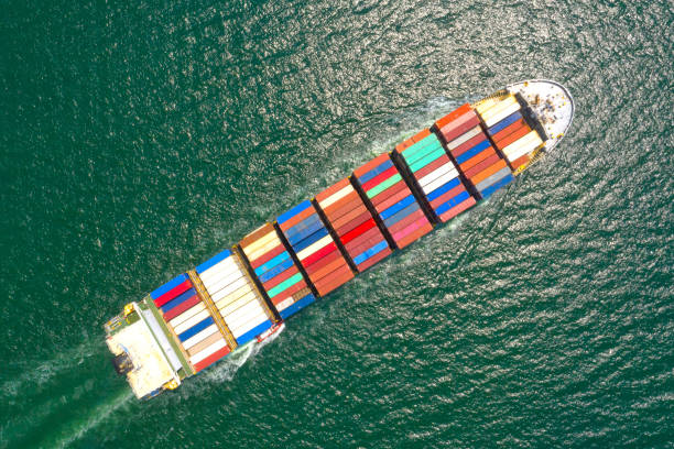 istock Container , container ship in export and import business and logistics. Shipping cargo to harbor by crane. Water transport International. Aerial view and top view. 1225410360
