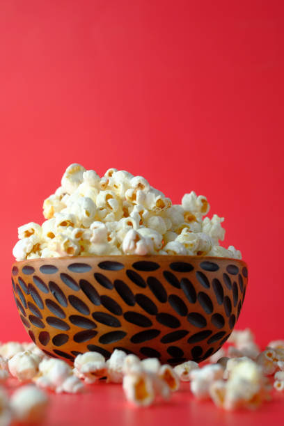 Close up of popcorn in a bowl on red background