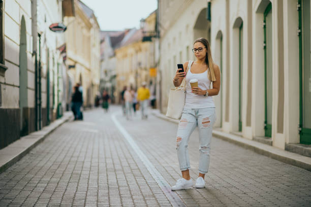 istock Woman using smartphone in the city 1225411819
